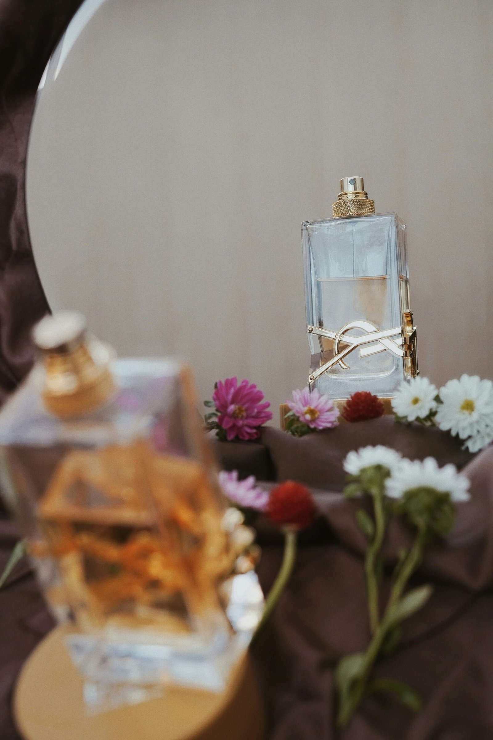 Clear glass perfume bottle on brown wooden table